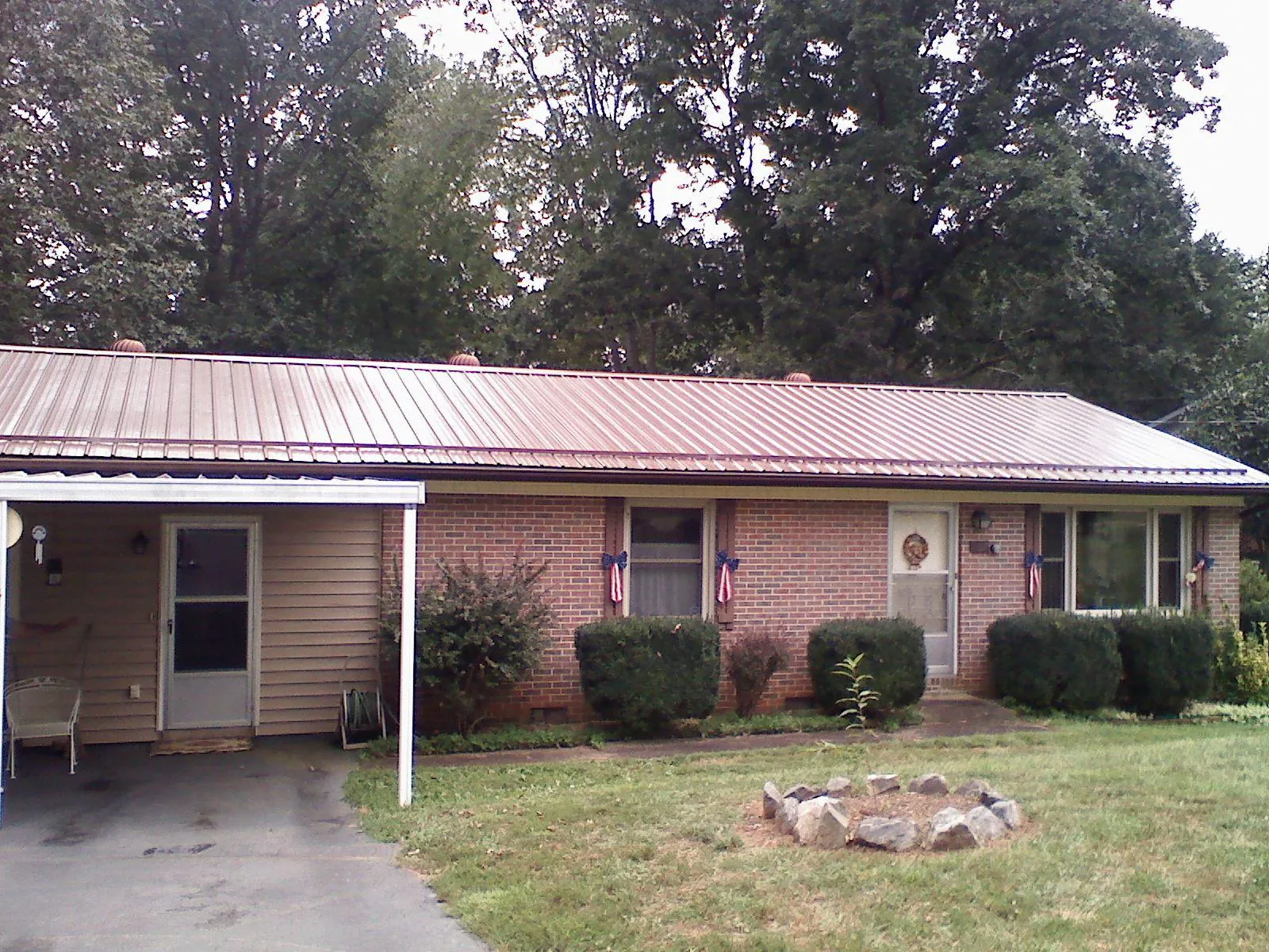 Bronze metal roof and carport on a brick ranch home — Roof Repair work by our crew in Creola